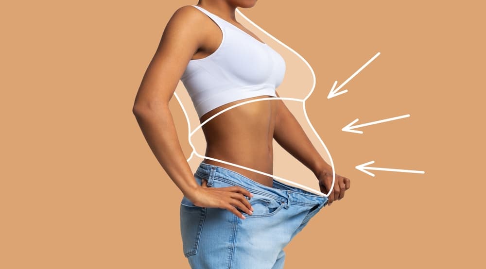 Lady wearing loose jeans after losing a considerable amount of weight