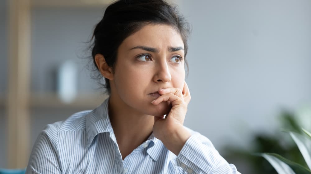 A lady looking uncertain as to what could help her treat her medical health condition.