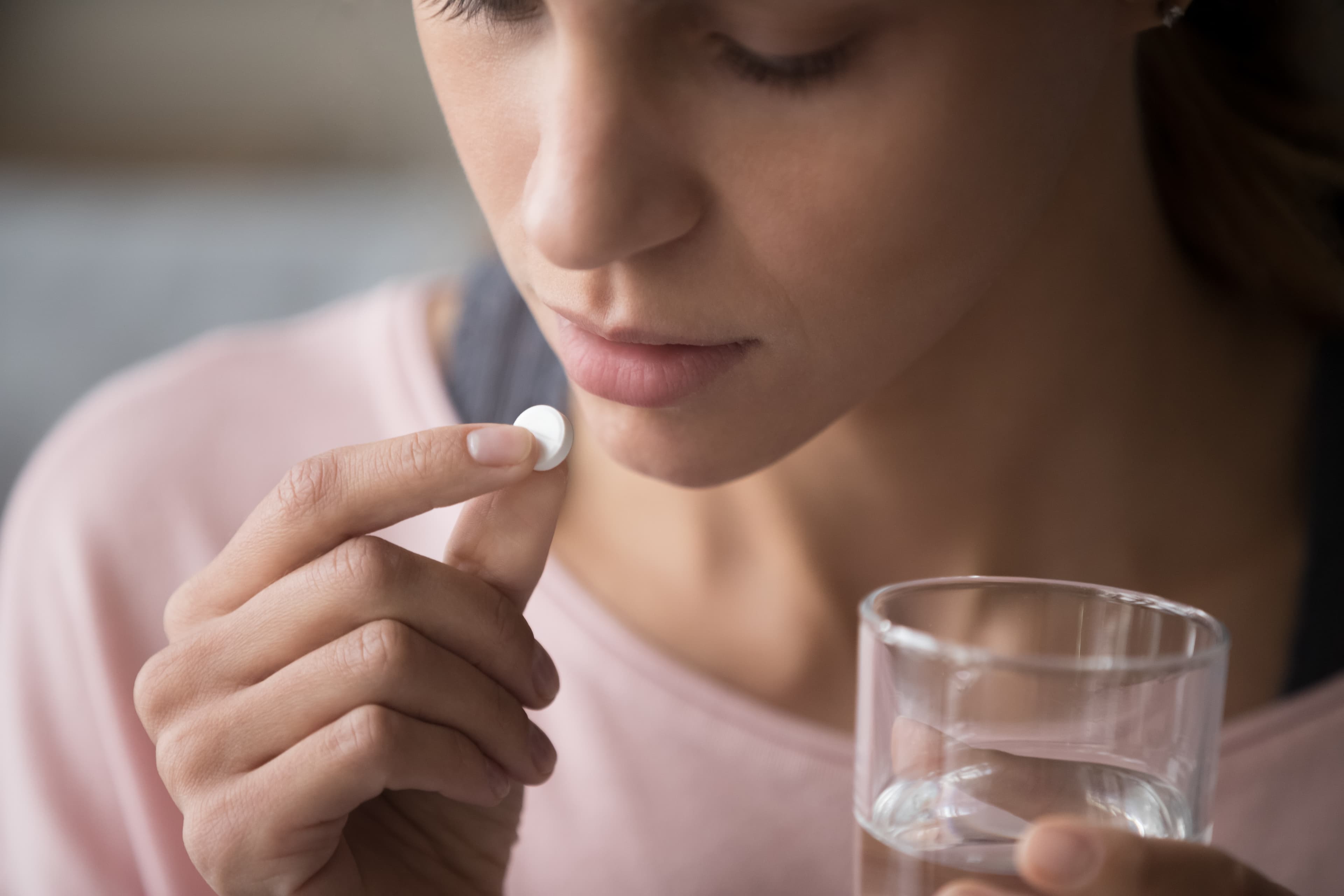 A lady taking a Zopiclone tablet