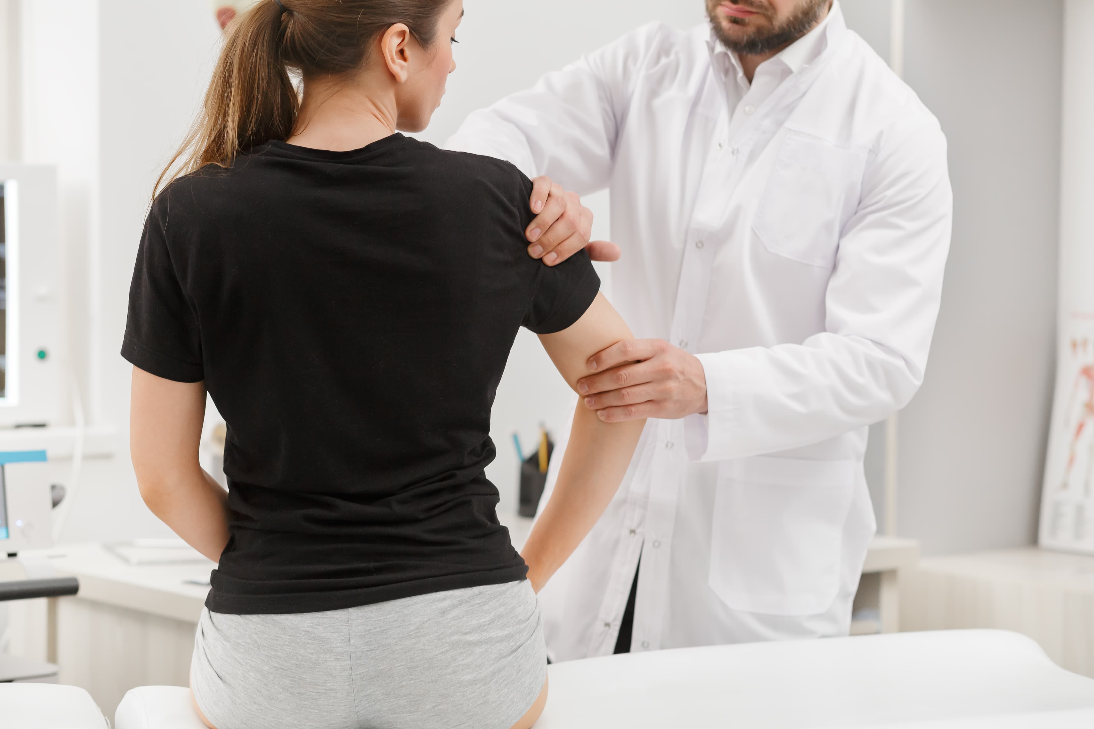 A doctor assessing a patient in person