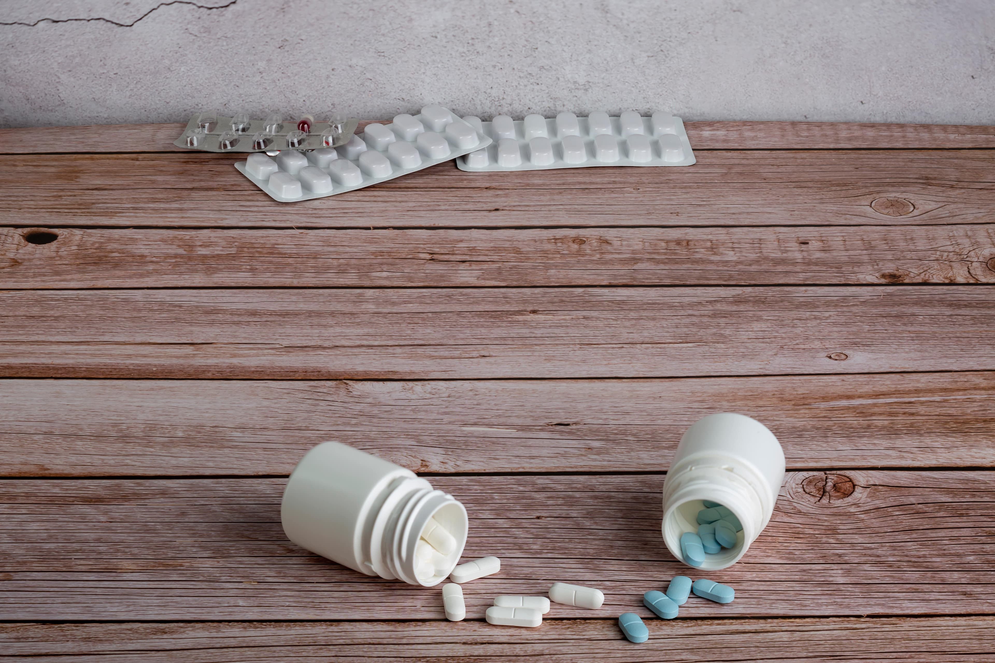 Alprazolam and Diazepam tablets spilling out of two separate containers