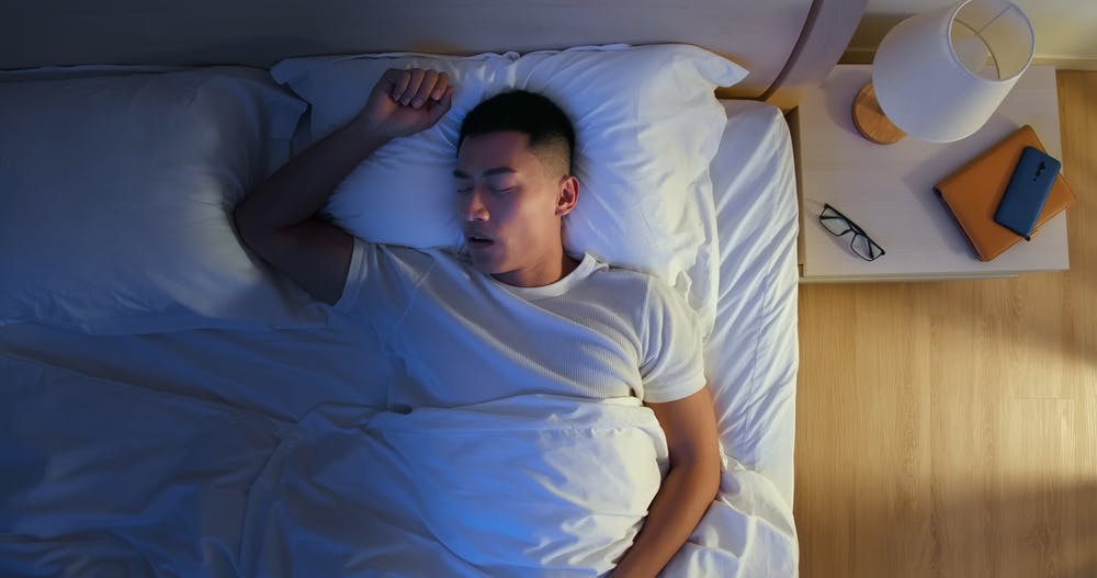 Guy sleeping in bed 