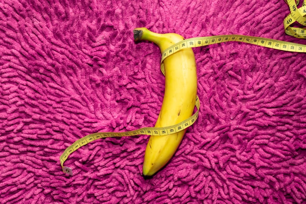 A banana with a tape measure wrapped around it to represent a penis